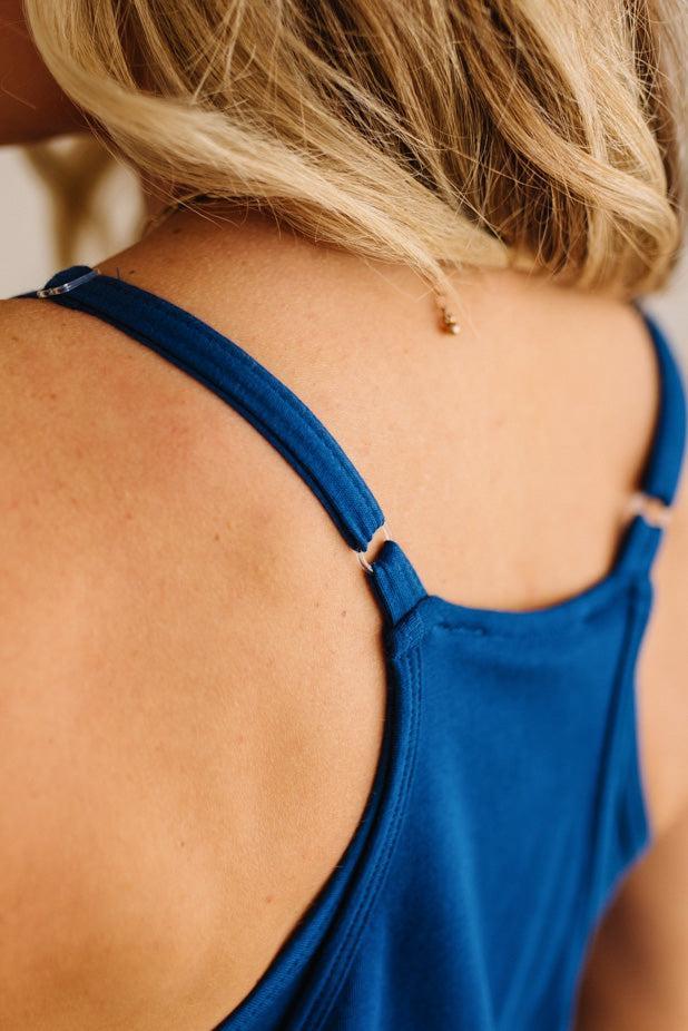Blue tank top worn by a person with blonde hair, focusing on the back view.
