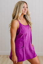 Woman wearing a purple dress against a plain background