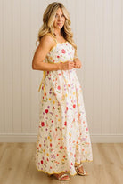 Woman wearing a floral dress against a plain background