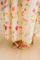 Floral-patterned sheer fabric with colorful flowers on a beige background