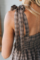 Plaid halter top worn by a person with a blurred background