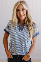 Woman wearing a striped shirt with a neutral background