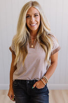 Woman wearing a striped shirt with a plain background