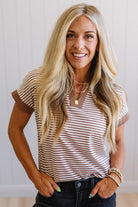 Woman wearing a striped shirt with a neutral background