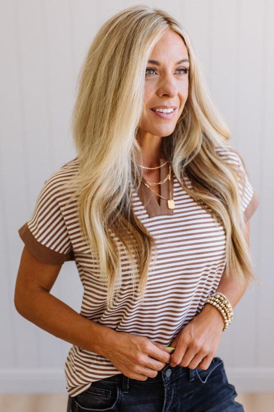 Woman wearing a striped shirt with a neutral background