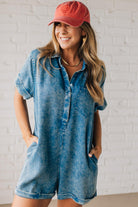 BLONDE WOMAN WEARING A TENCEL MINERAL WASHED HALF BUTTON SHIRTS ROMPER WITH POCKETS.