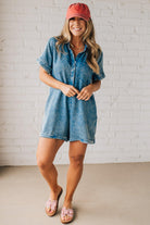 BLONDE WOMAN WEARING A TENCEL MINERAL WASHED HALF BUTTON SHIRTS ROMPER WITH POCKETS.