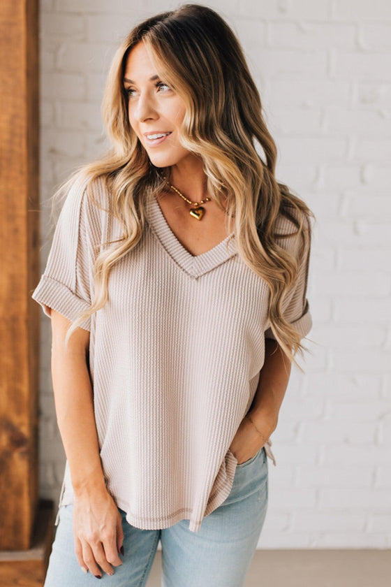 women modeling a creamy neutral short sleeve corded v neck top