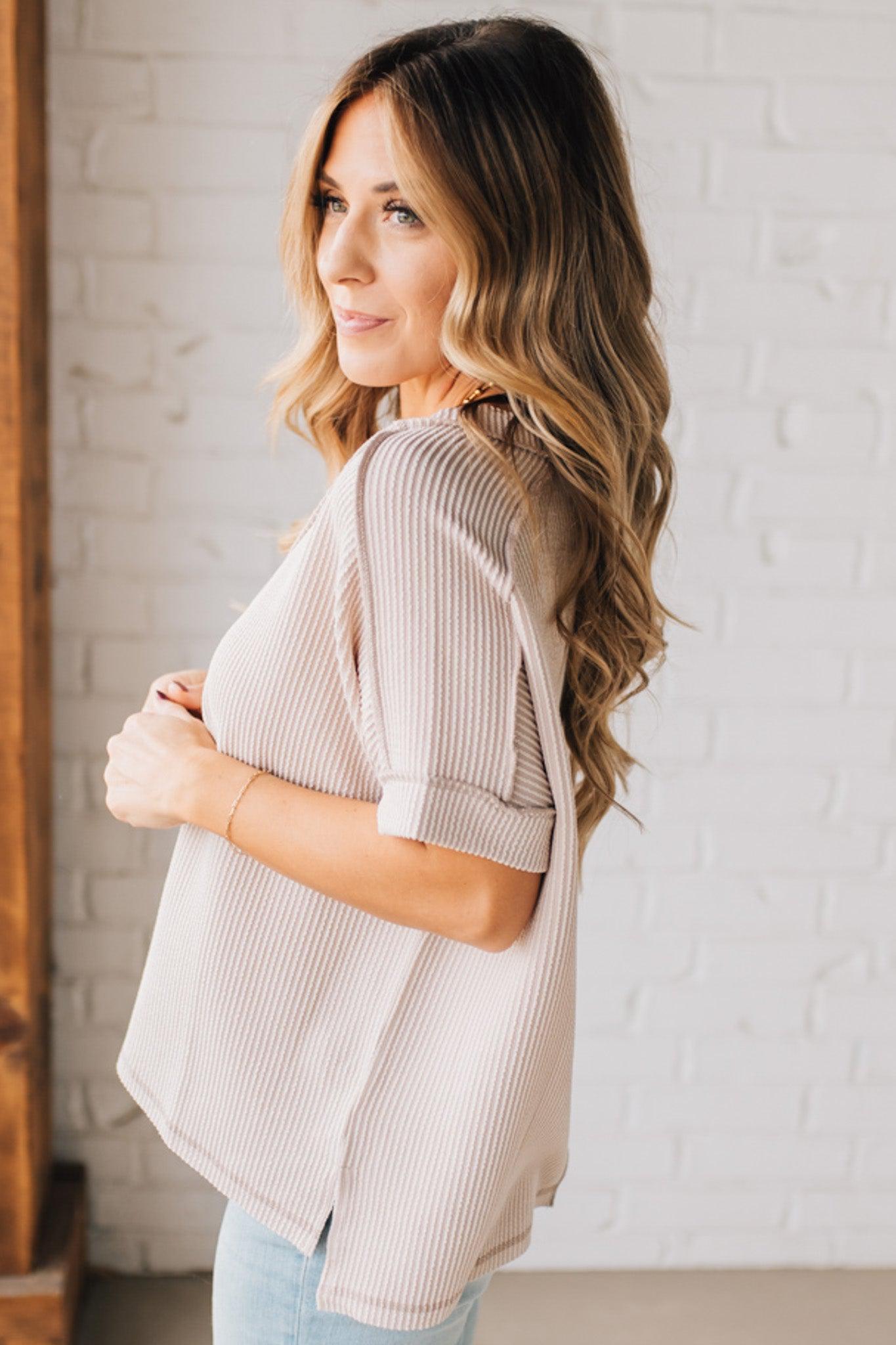 women modeling a creamy neutral short sleeve corded v neck top