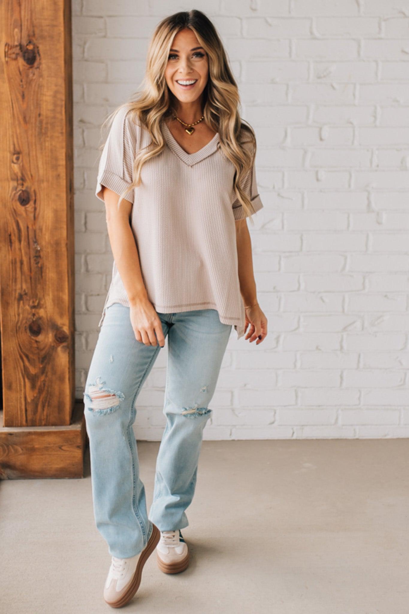 women modeling a creamy neutral short sleeve corded v neck top