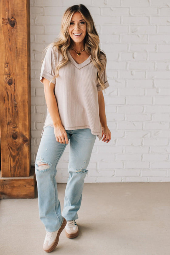 women modeling a creamy neutral short sleeve corded v neck top