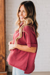 women modeling a burgundy short sleeve corded v neck top