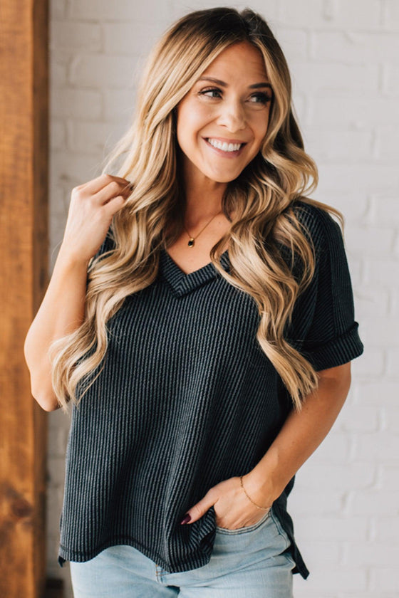 women modeling a black short sleeve corded v neck top