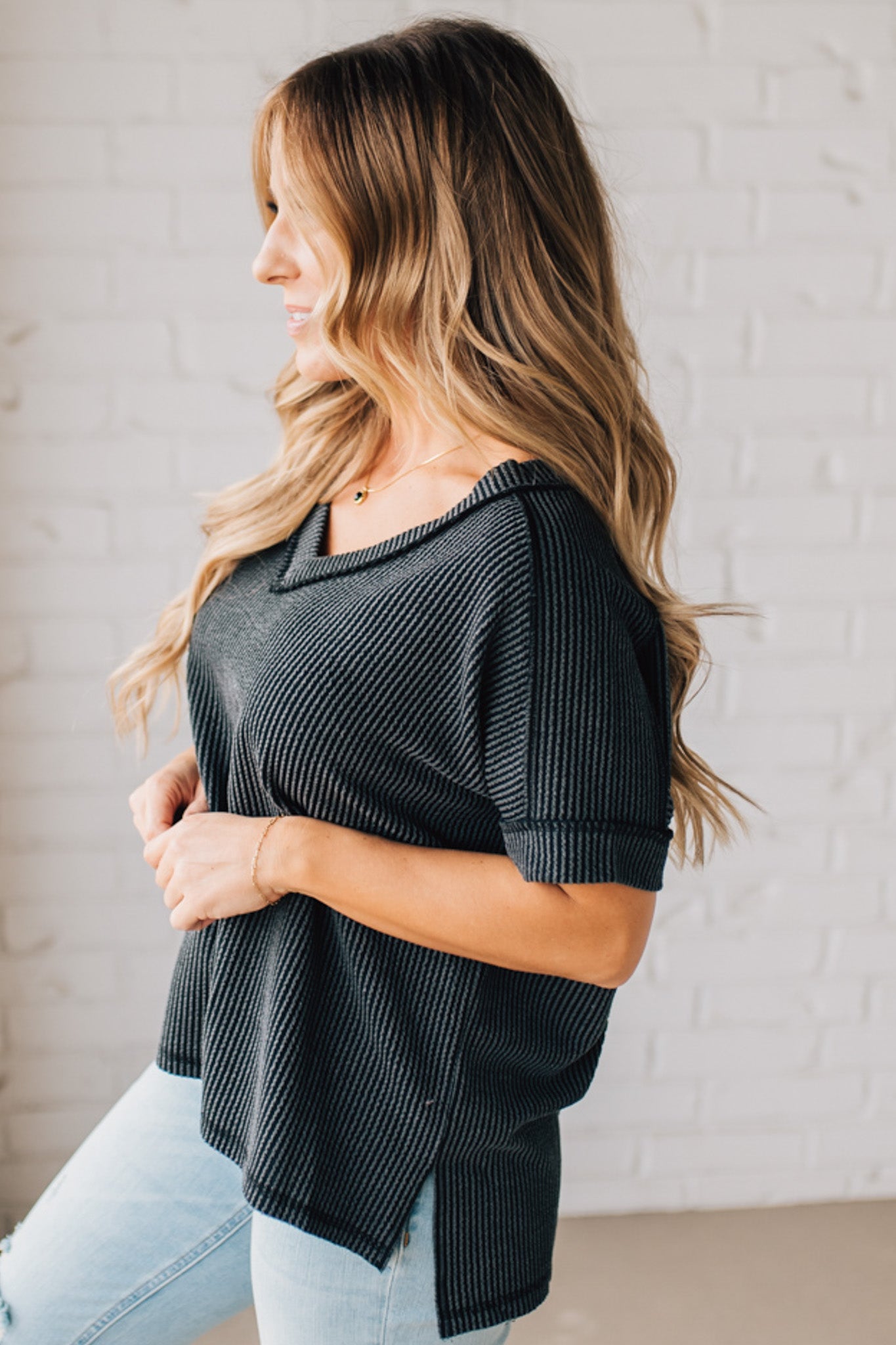 women modeling a black short sleeve corded v neck top