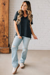 women modeling a black short sleeve corded v neck top