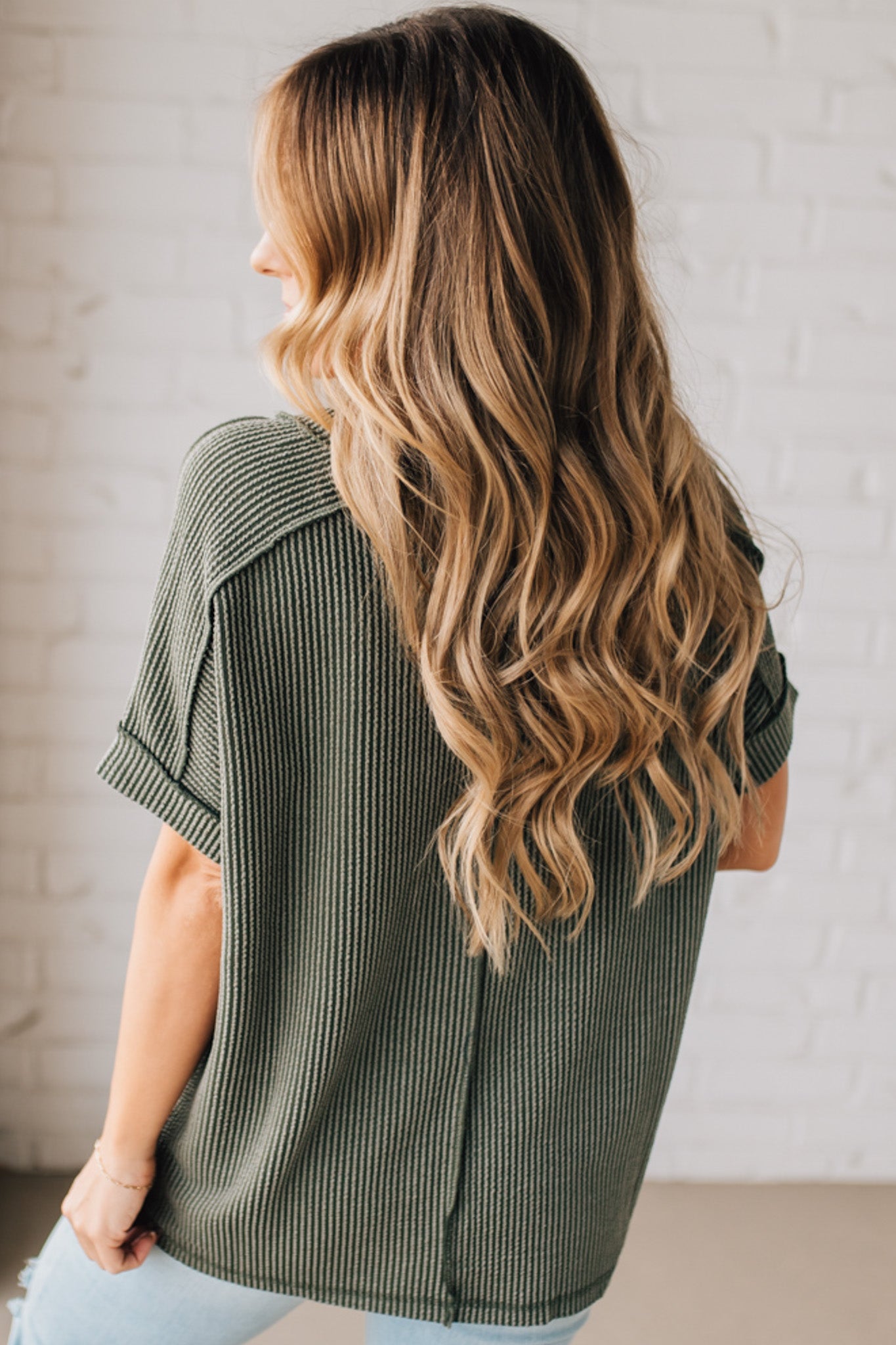 women modeling a olive short sleeve corded v neck top