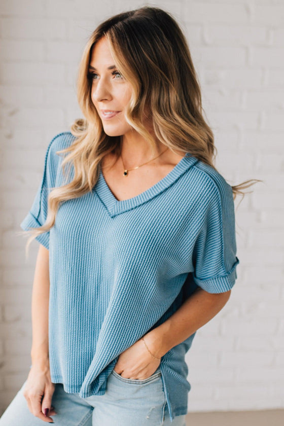 women modeling a dusty blue short sleeve corded v neck top