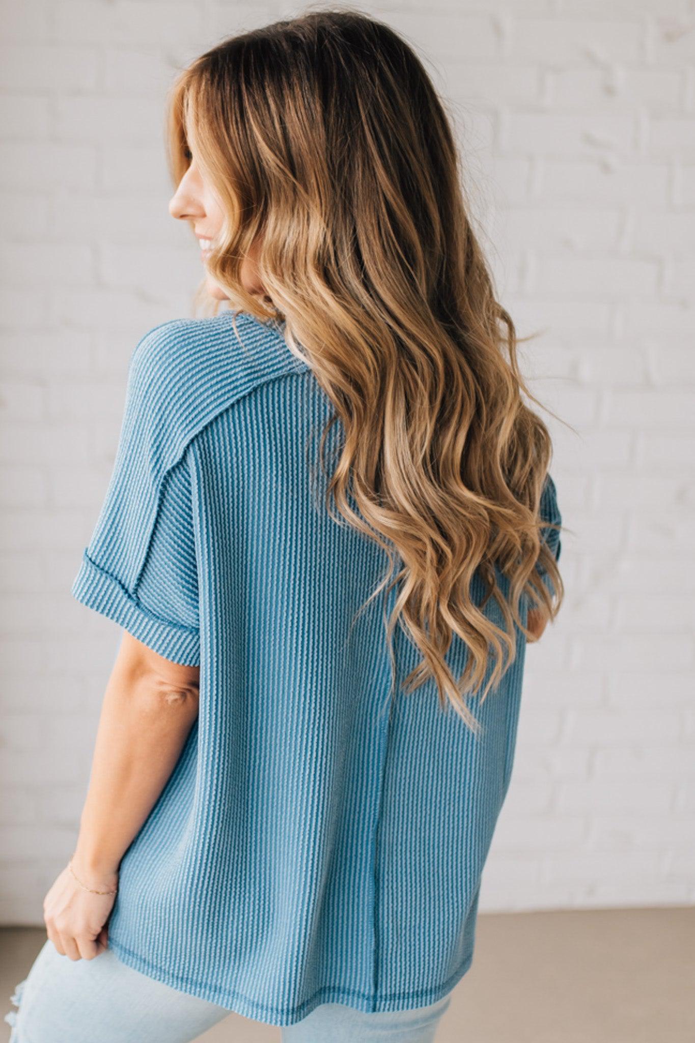 women modeling a dusty blue short sleeve corded v neck top