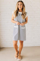 Blonde Woman Wearing a Drop cap sleeves tiny checker print shift dress with pocket, solid contrast accent.