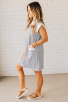 Blonde Woman Wearing a Drop cap sleeves tiny checker print shift dress with pocket, solid contrast accent.
