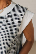Blonde Woman Wearing a Drop cap sleeves tiny checker print shift dress with pocket, solid contrast accent.