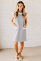 Blonde Woman Wearing a Drop cap sleeves tiny checker print shift dress with pocket, solid contrast accent.