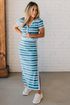 Blonde woman wearing a light blue and medium blue striped sweater ribbed maxi skirt with ribbed stretch waistband, and high side slit.