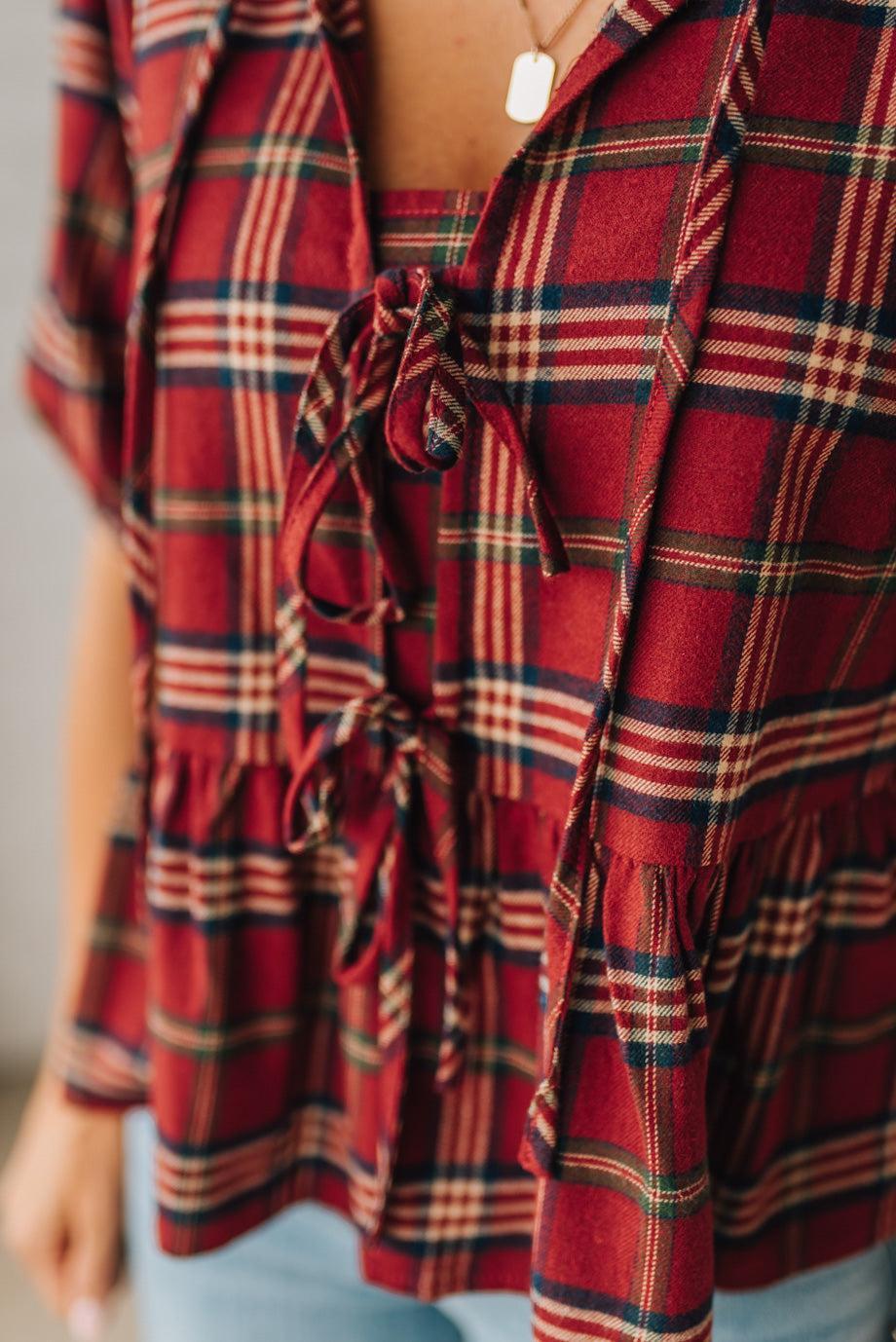 Red plaid dress with a tie waist on a neutral background