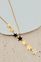 Necklace with star-shaped pendants on a light background