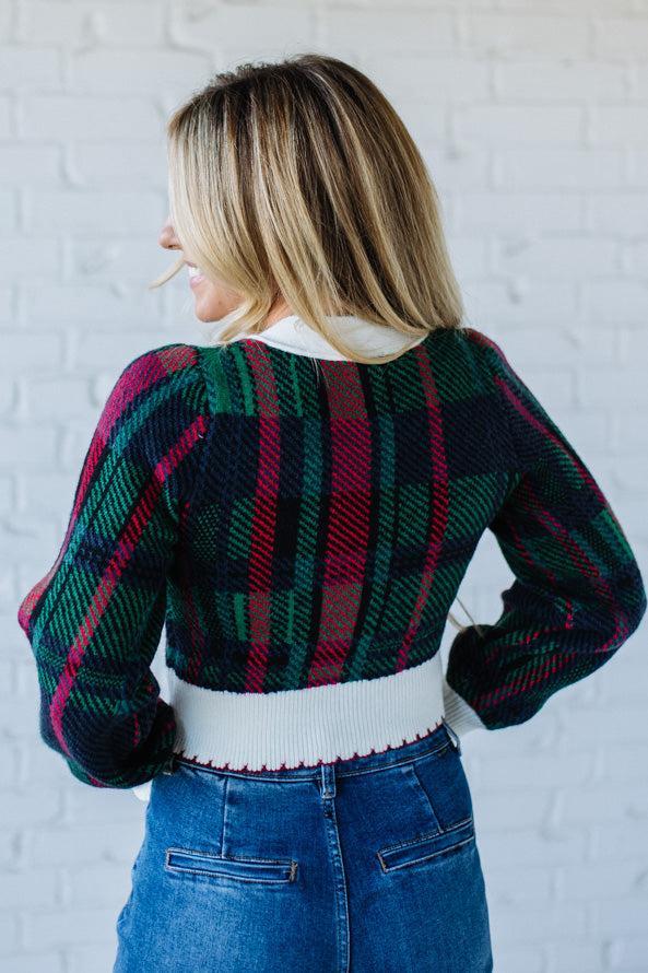 BLONDE WOMAN WEARING A VELVET BOW RIBBON EMBELLISHED CHRISTMAS CHECKER PLAID BUTTONED SWEATER CROP CARDIGAN