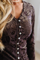 BLONDE WOMAN IN DARK JEANS WEARING A ROMANTIC VELVET BURNOUT TOP WITH FEATURES LIKE, BURNOUT VELVET MESH FABRICATION, SCALLOPED LACE EDGE ACCENTS, FUNCTIONAL BUTTONS AND LONG SLEEVES