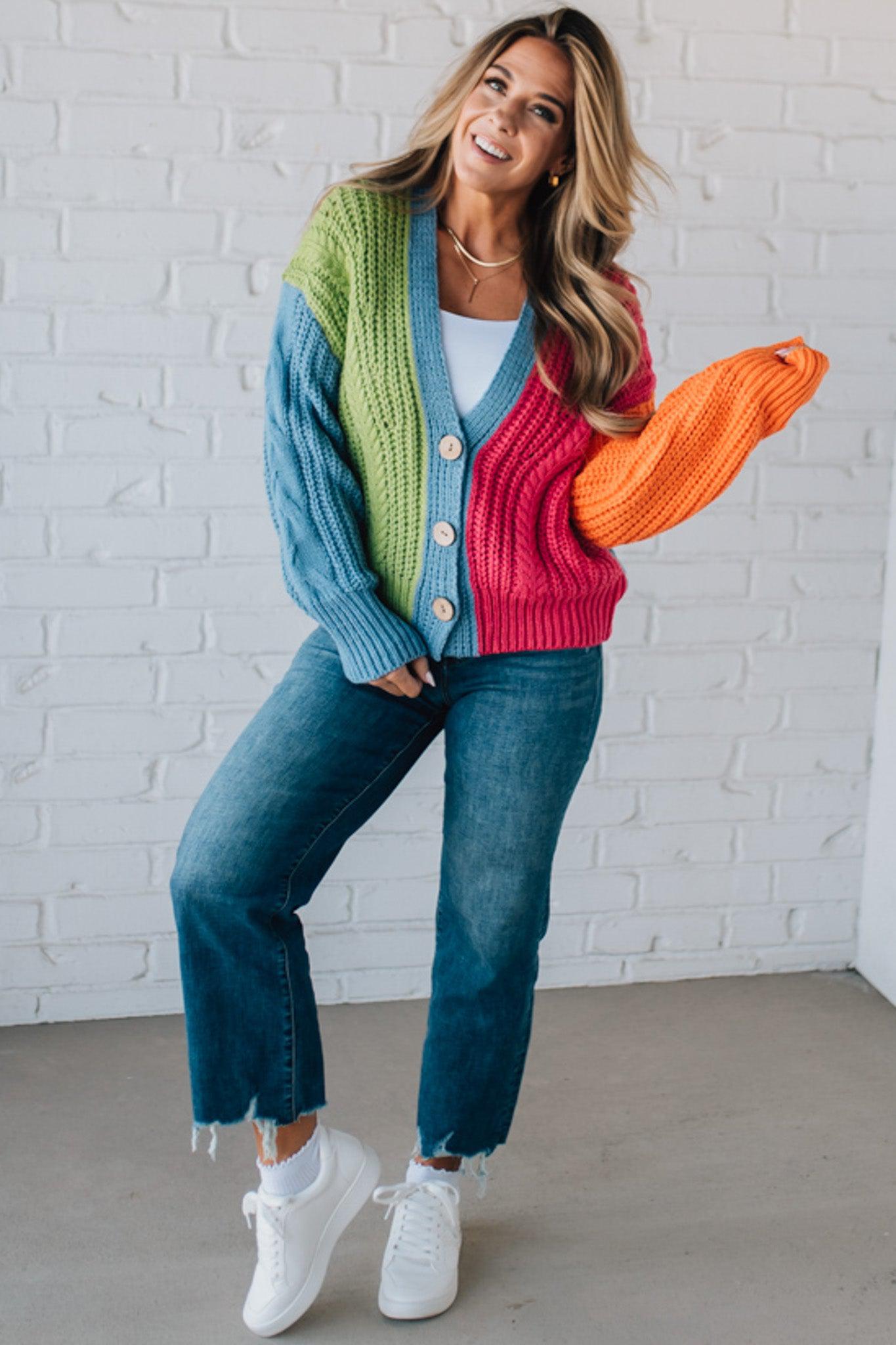 blonde girl modeling a bright colorblock cardigan with chunky wood buttons