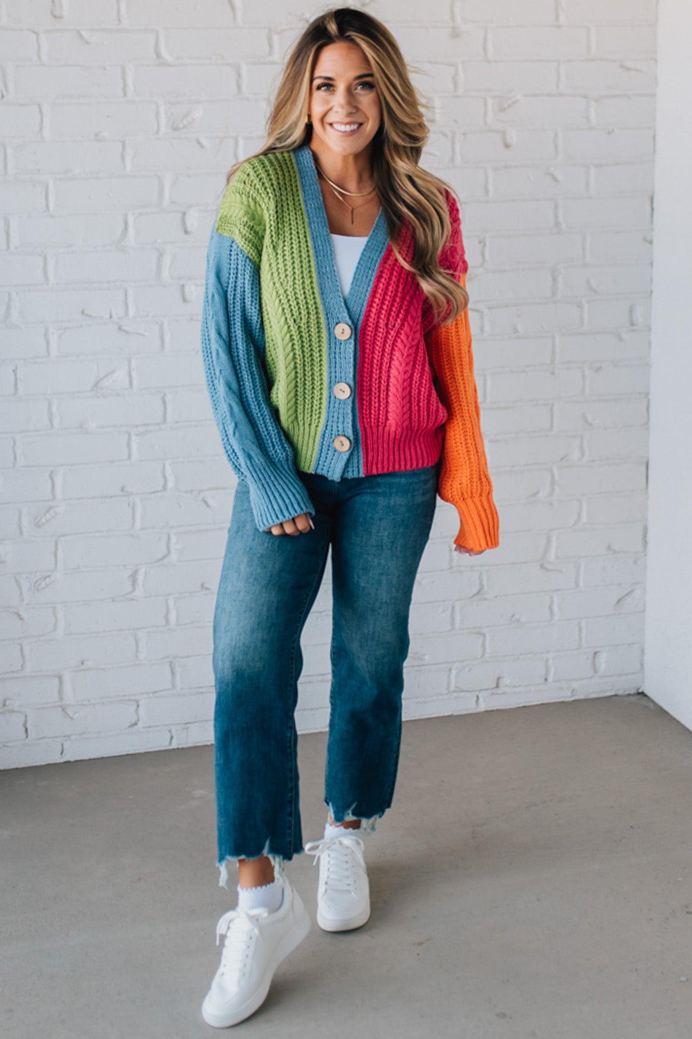 blonde girl modeling a bright colorblock cardigan with chunky wood buttons