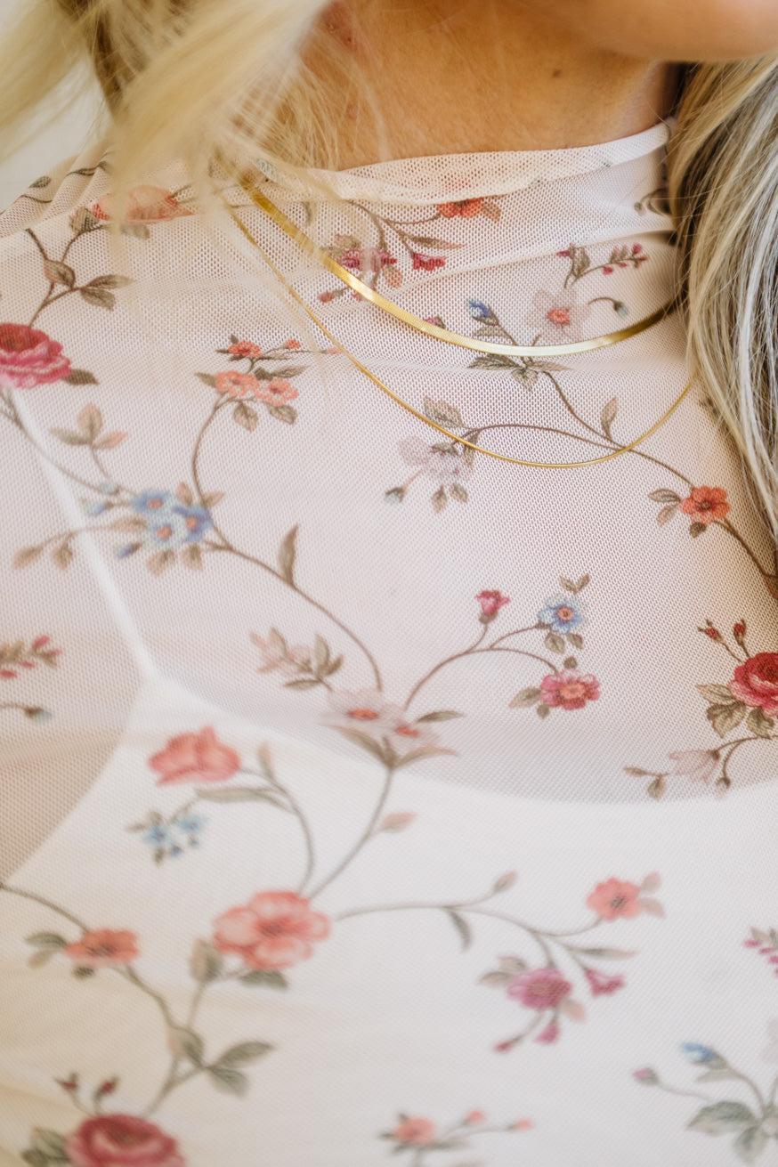 Close-up of a floral-patterned fabric with a gold trim