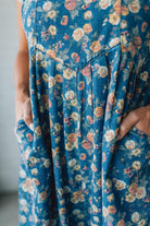 Close-up of a blue floral overall set with a blurred background
