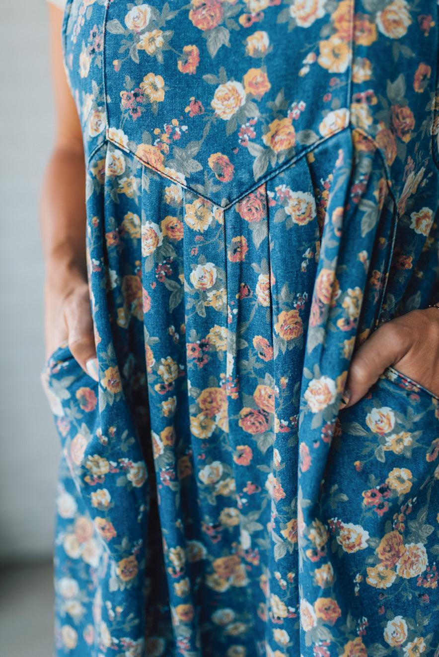 Close-up of a blue floral overall set with a blurred background