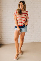 Blonde woman wearing a beige, red, and navy Stripe Drop Shoulder Sweater Top.