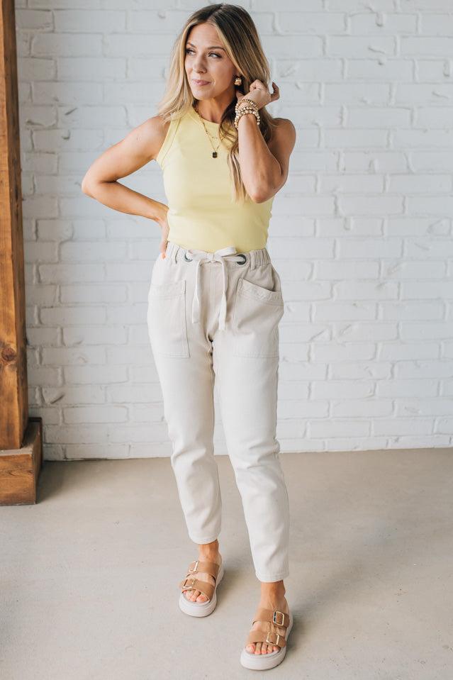 Blonde Woman in a Yellow Tank Wearing Vintage Washed Slim Barrel Pants With Front Patch Pockets and a Chunky Drawstring Waist.