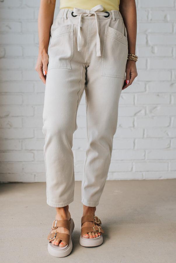 Blonde Woman in a Yellow Tank Wearing Vintage Washed Slim Barrel Pants With Front Patch Pockets and a Chunky Drawstring Waist.