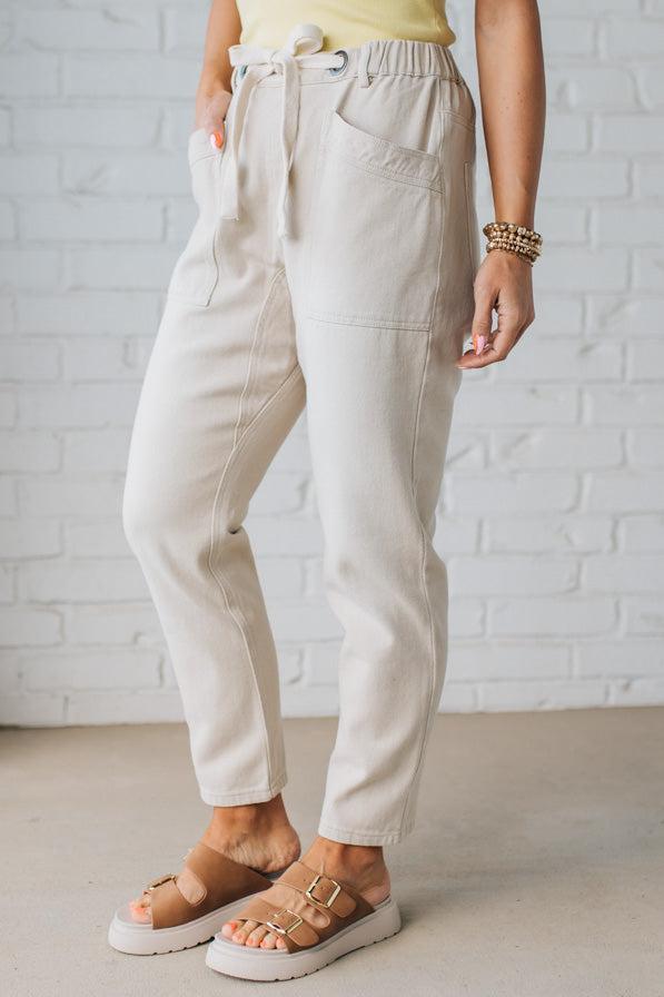 Blonde Woman in a Yellow Tank Wearing Vintage Washed Slim Barrel Pants With Front Patch Pockets and a Chunky Drawstring Waist.