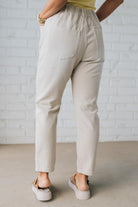 Blonde Woman in a Yellow Tank Wearing Vintage Washed Slim Barrel Pants With Front Patch Pockets and a Chunky Drawstring Waist.