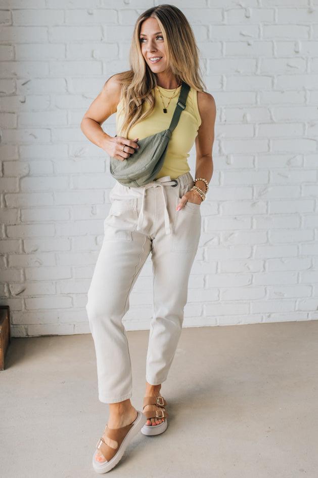 Blonde Woman in a Yellow Tank Wearing Vintage Washed Slim Barrel Pants With Front Patch Pockets and a Chunky Drawstring Waist.