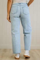 Light blue jeans worn by a person on a neutral background