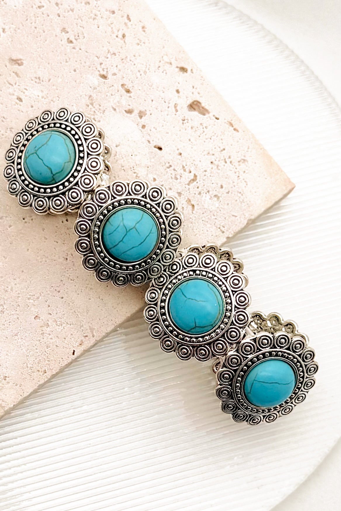 Western Concho Turquoise Stretch Bracelet on a textured surface.