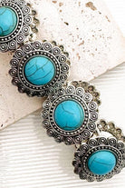 Western Concho Turquoise Stretch Bracelet on a textured surface.