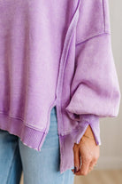 Purple oversized sweater with a neutral background