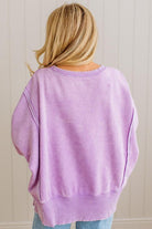 Person wearing a light purple oversized sweater against a neutral background