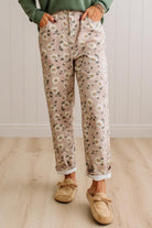Woman Standing on Light Wood Floor with a Paneled Wall behind and wearing a green shirt, light tan slip on loafers and Delicate Wildflower Harmony Classic Fit Trouser Pants.
