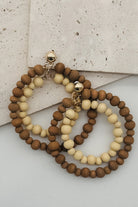 A pair of wood beaded hoop earrings.