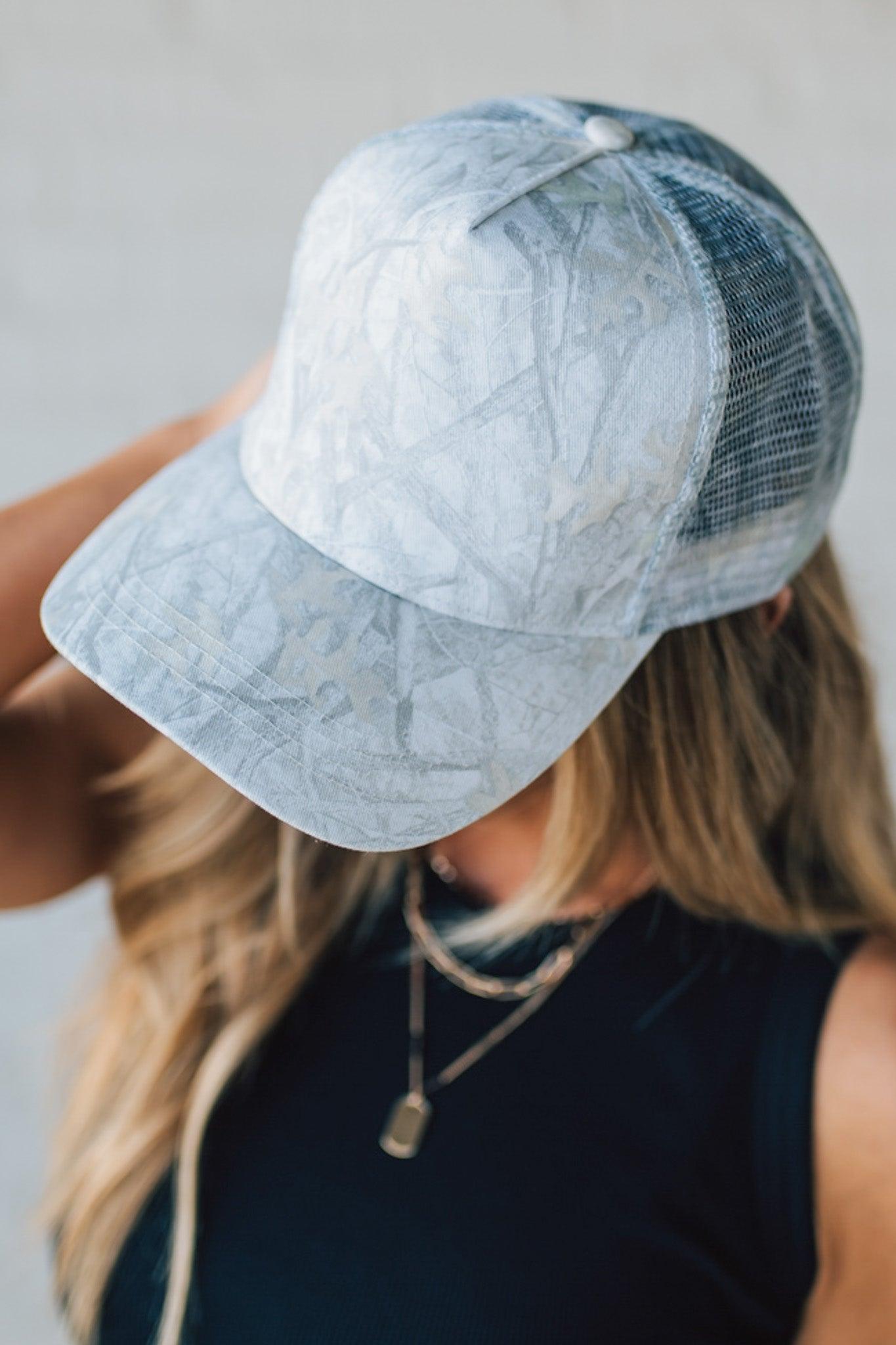 Blonde Woman Wearing a White Woods Print Mesh Back Trucker Cap.